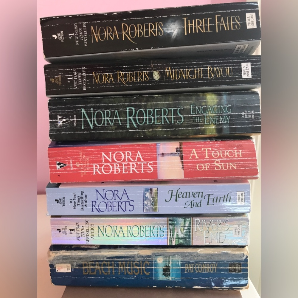 7 paperbacks. 6 Nora Roberts and one Pat Conroy
